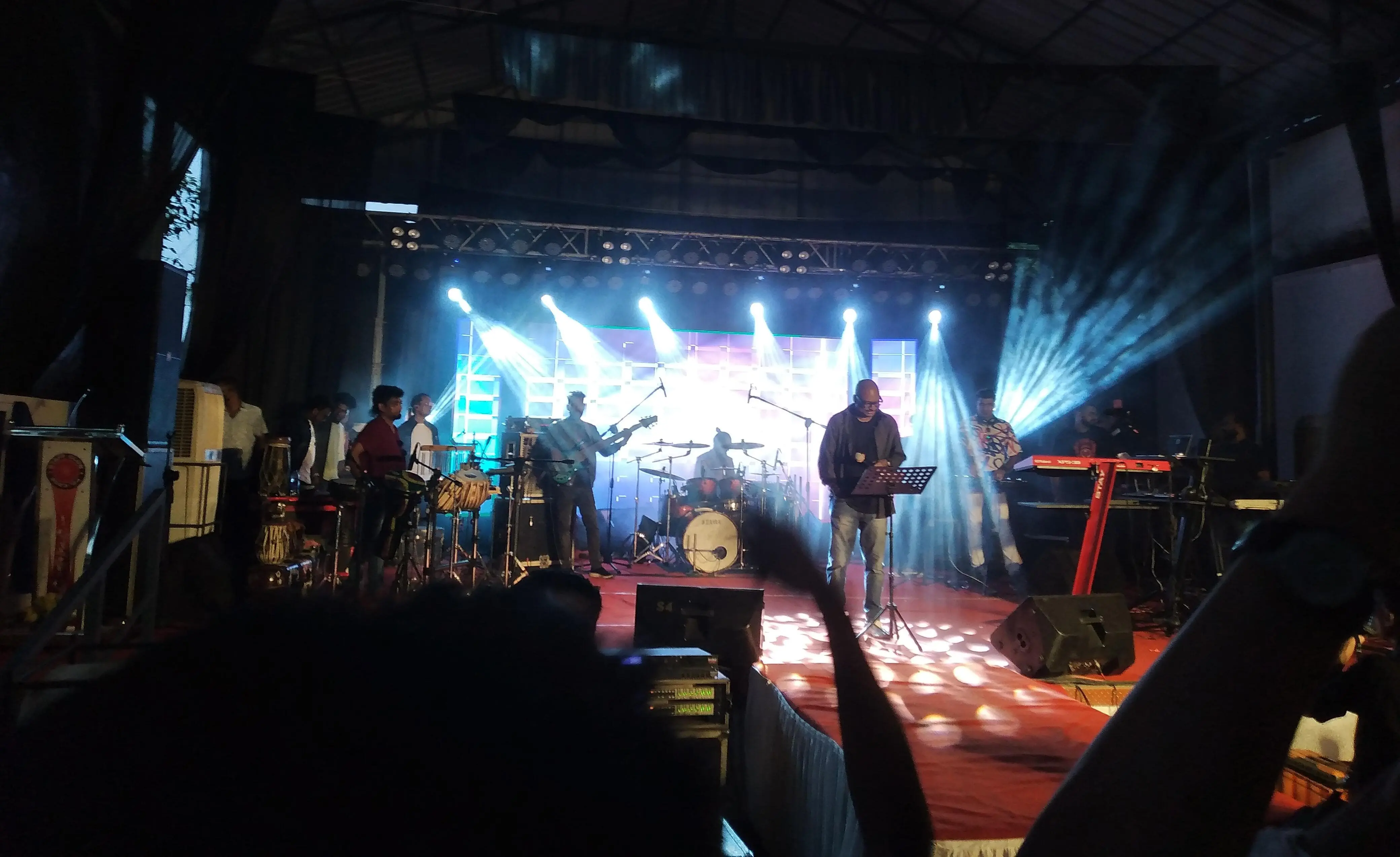 A group of people standing on stage with instruments in a concert.